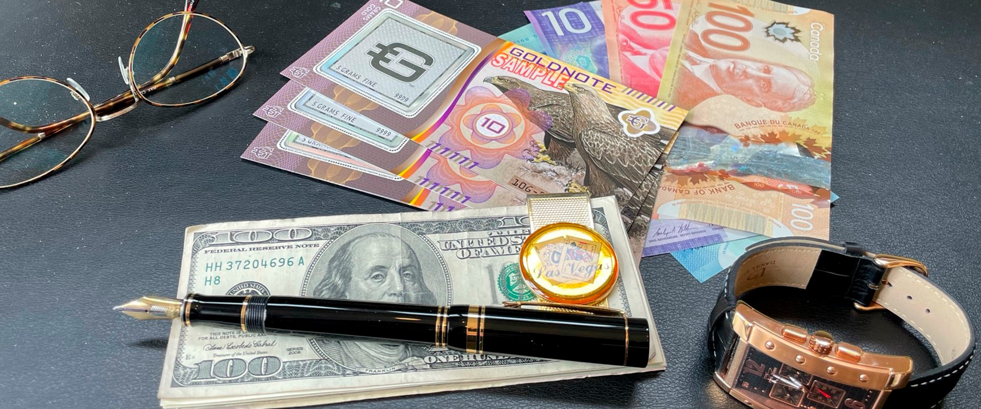 image of desk with money, elegant pen, glasses, watch and goldnotes. 